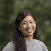 A woman with long dark hair.